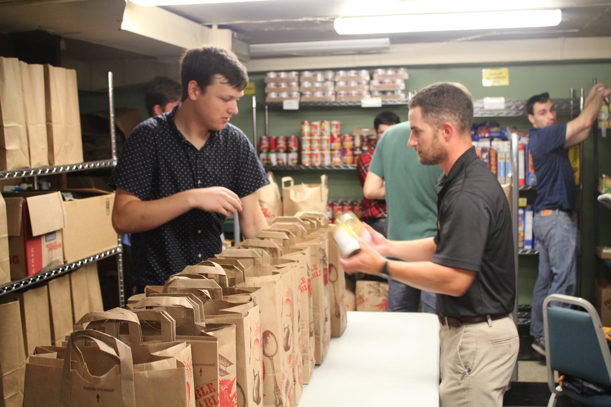 YCP volunteers pack grocery bags for low-income families